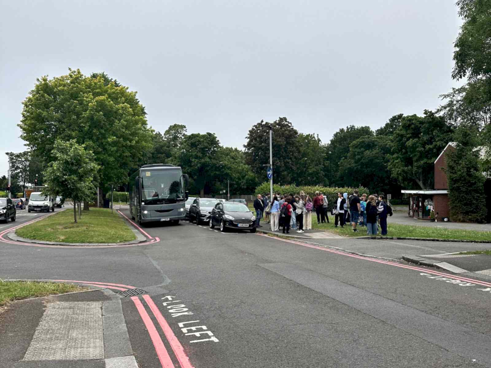 A coach and waiting students at the Shirley meeting point in West Wickham