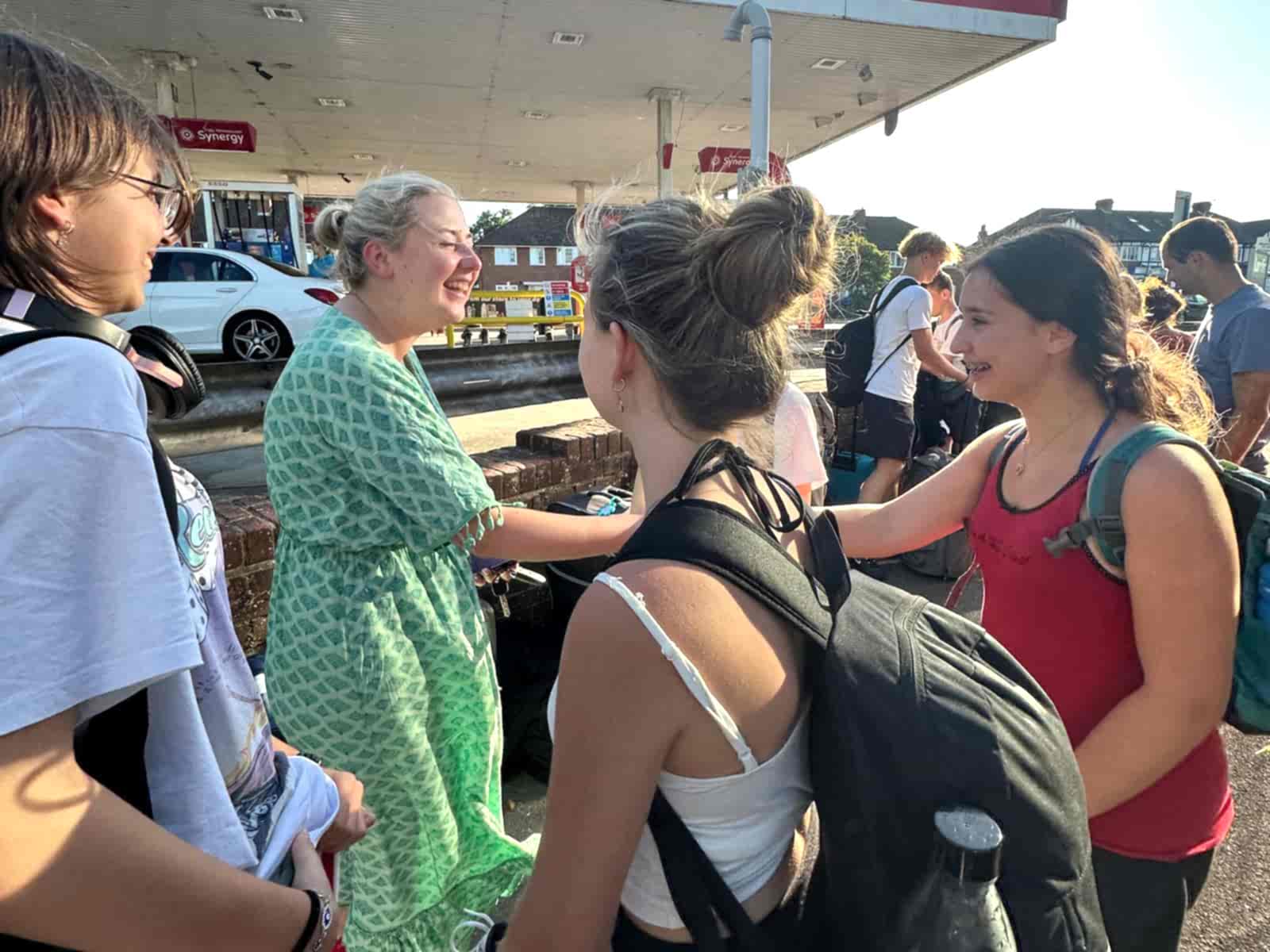 A host greeting students at the Beckenham meeting point